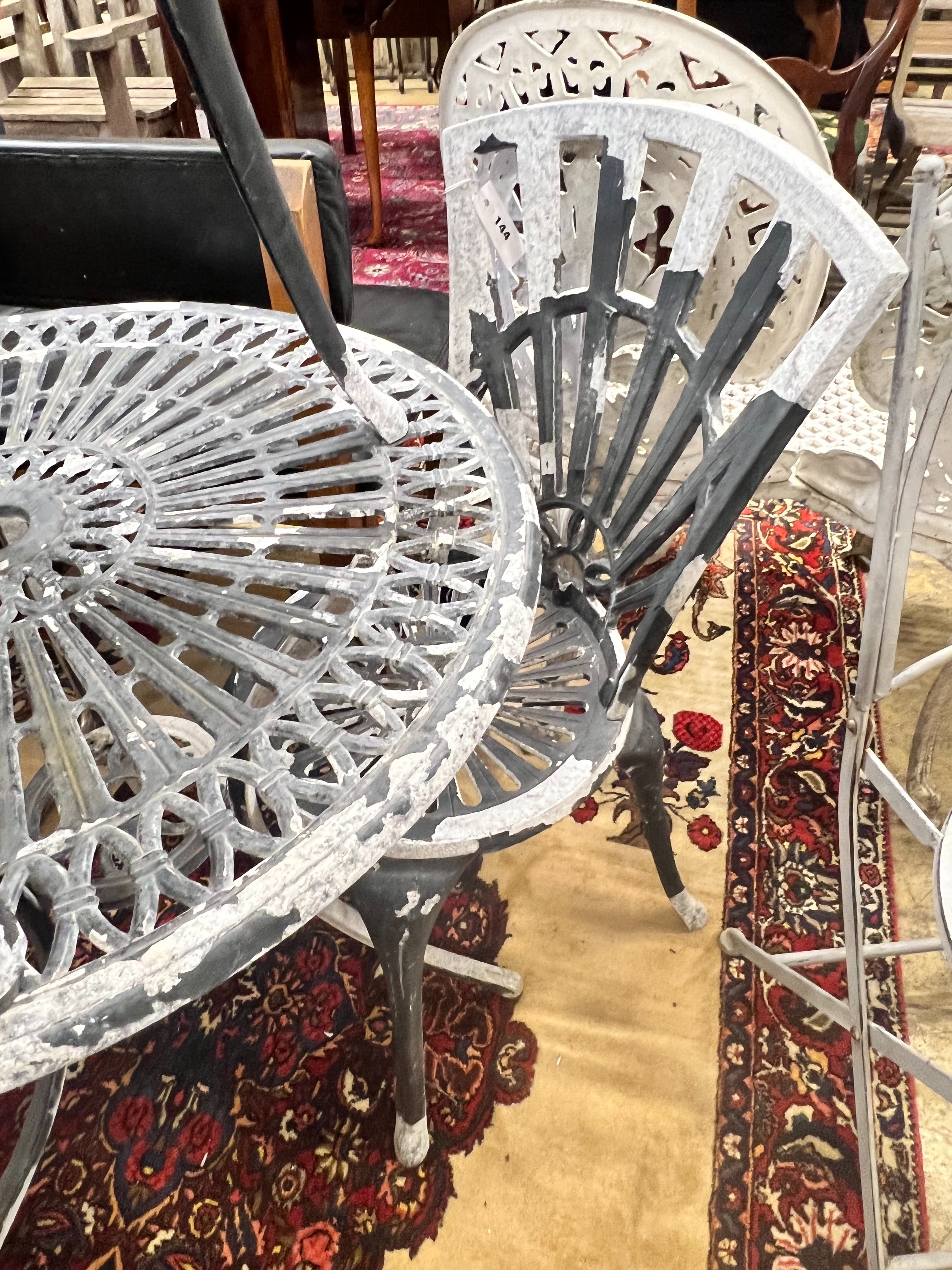 A circular aluminium garden table and two chairs, table diameter 69cm height 67cm